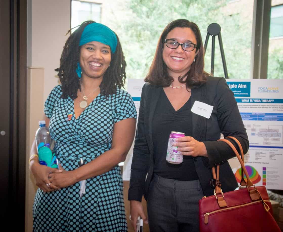 Two women posing for a photo at the Healthier Texas Summit in Austin, Texas