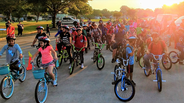 A large group of kids riding bikes